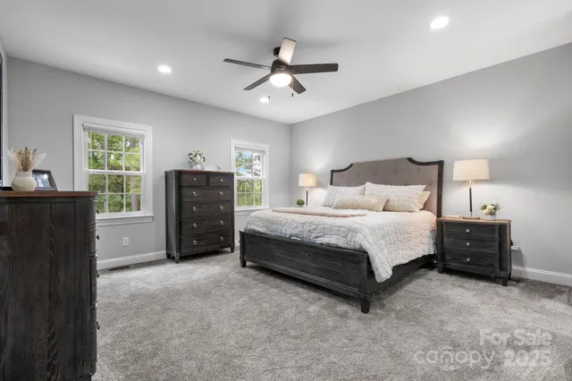 a spacious bedroom with a bed and a dresser