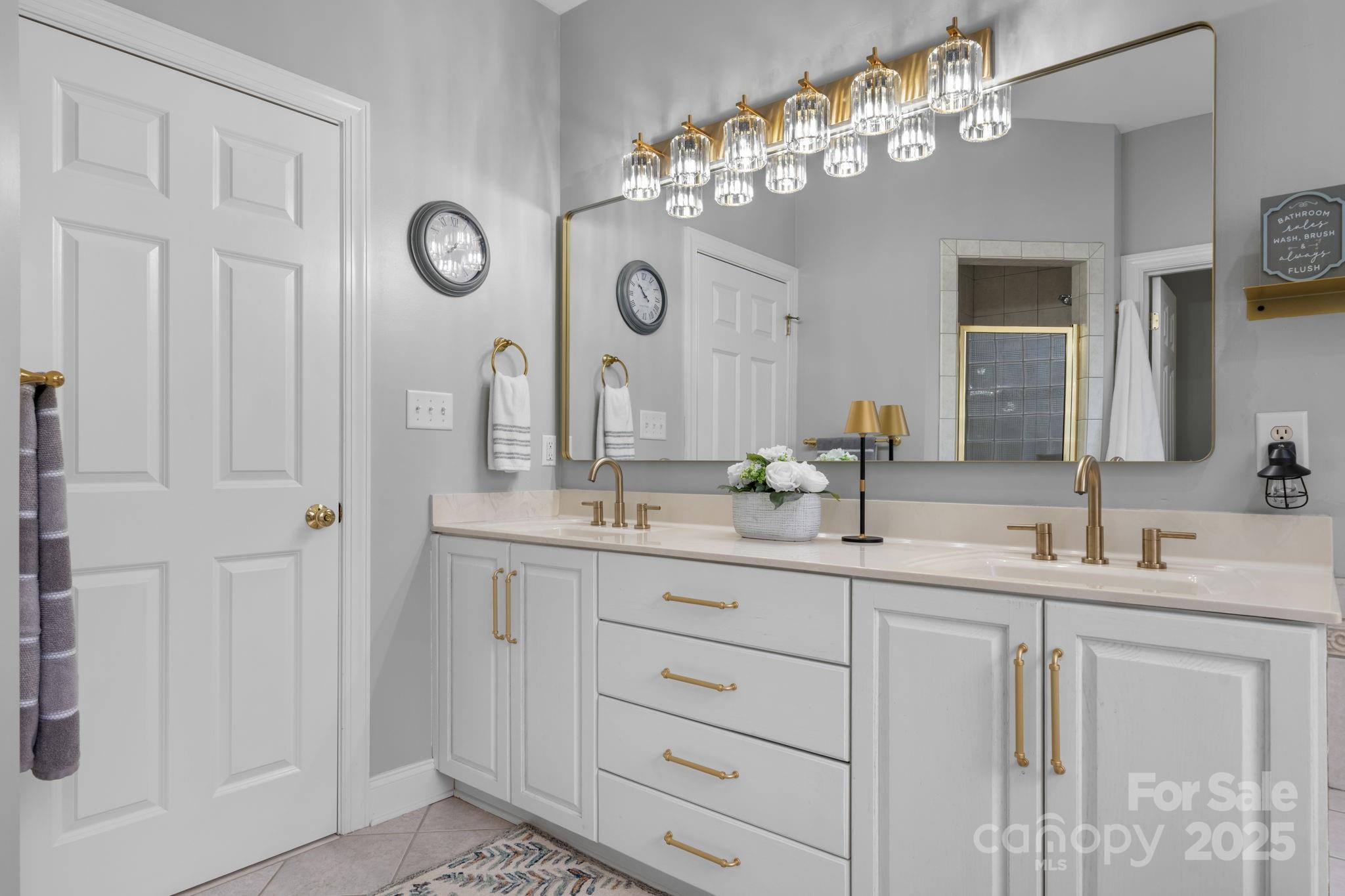 104 Blackhawk Ridge Court Granite Falls, NC 28630 - Photo 24 of 48 a bathroom with a double vanity sink and a mirror