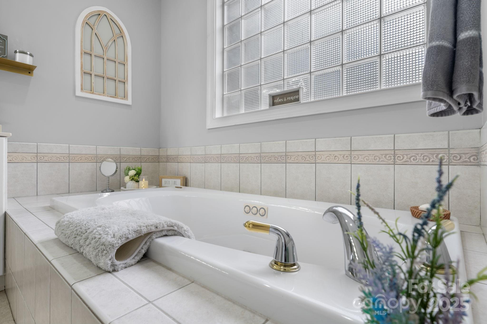 104 Blackhawk Ridge Court Granite Falls, NC 28630 - Photo 25 of 48 a bathroom with a tub and a sink