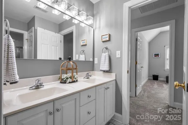 a bathroom with a sink double vanity and a mirror