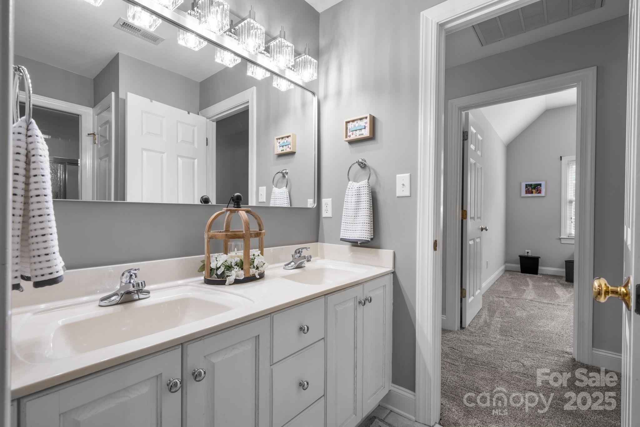 104 Blackhawk Ridge Court Granite Falls, NC 28630 - Photo 27 of 48 a bathroom with a sink double vanity and a mirror