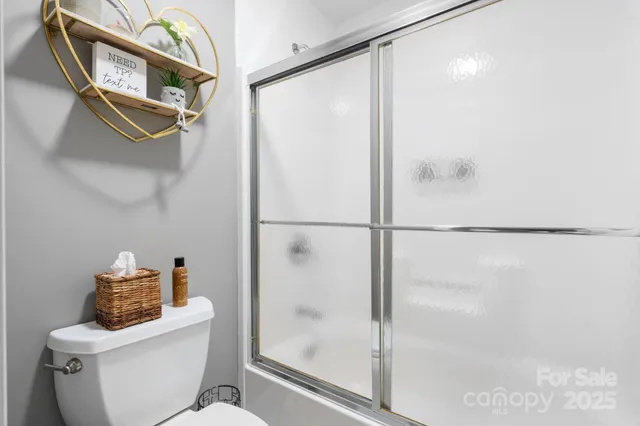 a bathroom with a shower a toilet and a sink