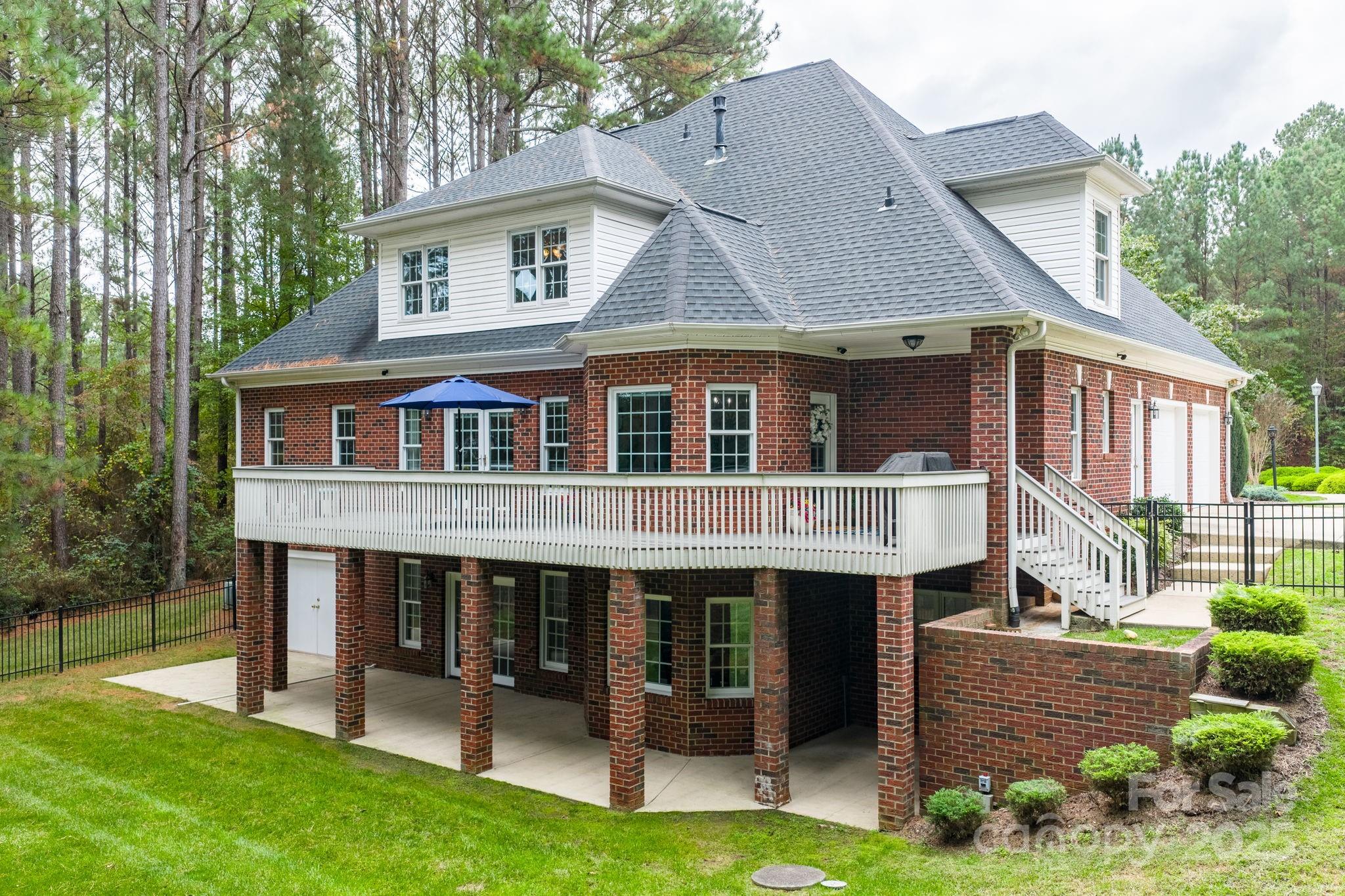 104 Blackhawk Ridge Court Granite Falls, NC 28630 - Photo 4 of 48 a front view of a house with a yard table and chairs