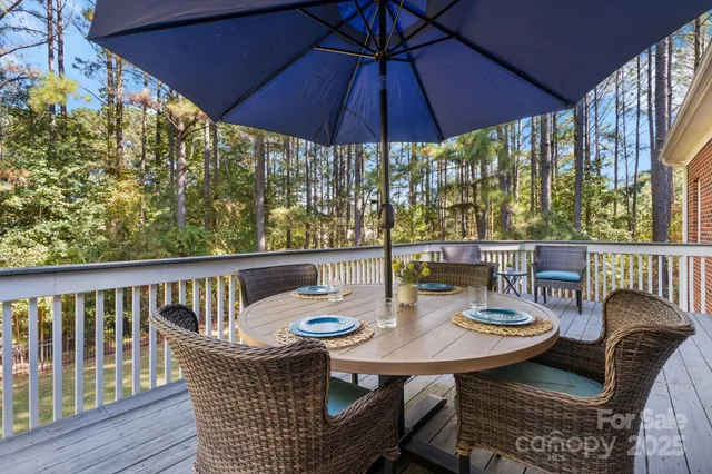 a view of balcony with furniture and umbrella