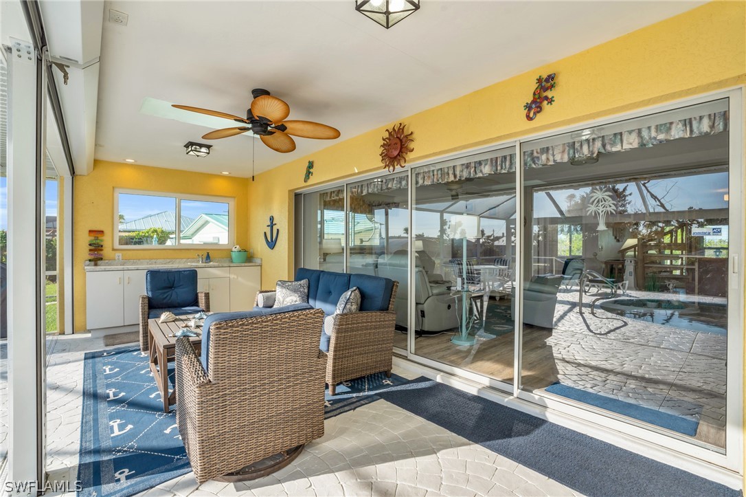 3278 York Road St. James City, FL 33956 - Photo 14 of 49 a living room with fireplace furniture and a floor to ceiling window