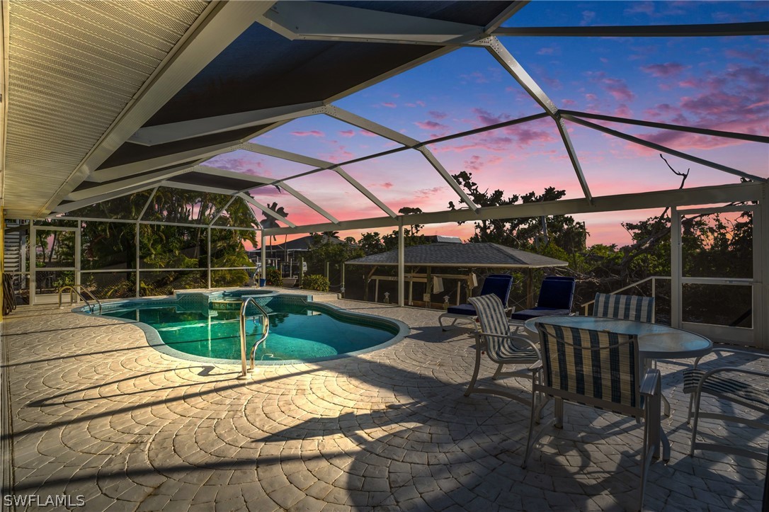 3278 York Road St. James City, FL 33956 - Photo 3 of 49 a view of a patio with a table and chairs under an umbrella