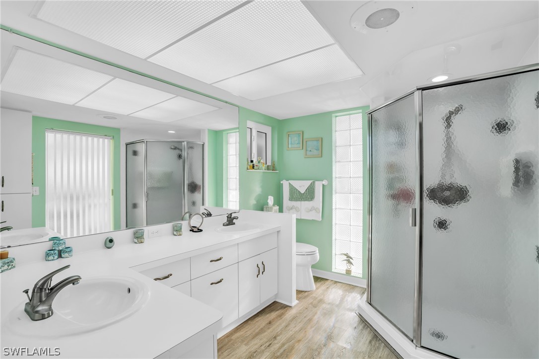 3278 York Road St. James City, FL 33956 - Photo 32 of 49 a spacious bathroom with a double vanity sink mirror and shower