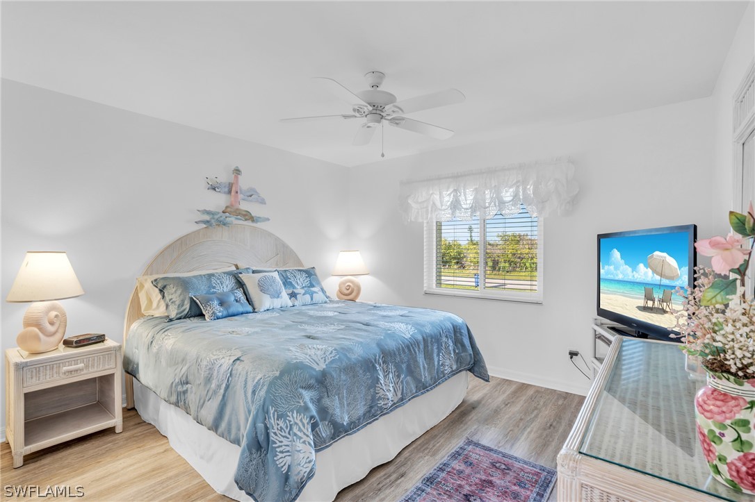 3278 York Road St. James City, FL 33956 - Photo 38 of 49 a bedroom with a bed and wooden floor