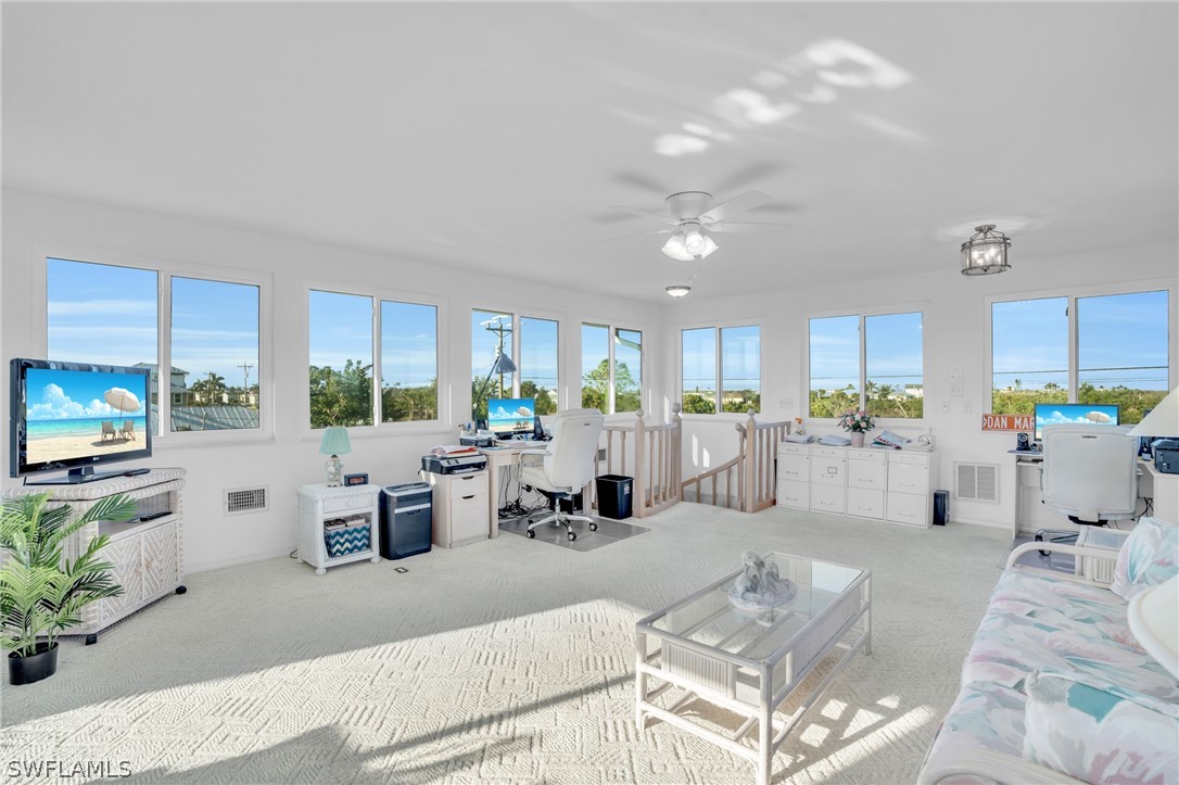 3278 York Road St. James City, FL 33956 - Photo 43 of 49 a living room with furniture potted plant and a large window
