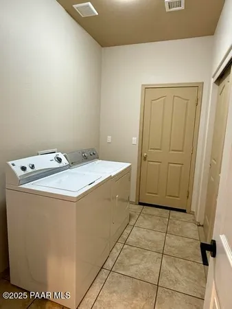an empty room with windows and cabinet