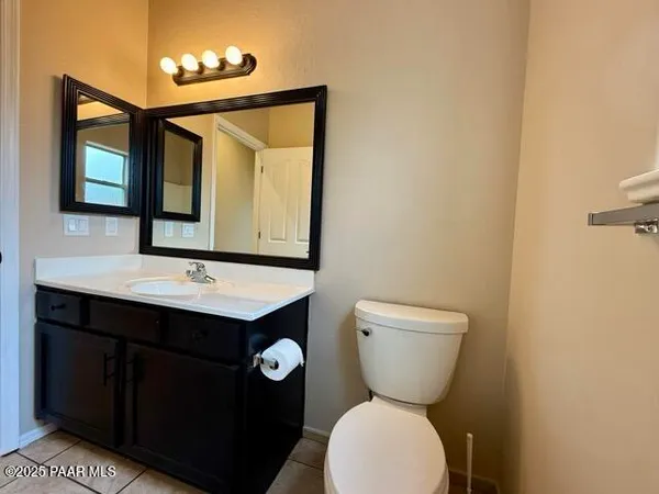 a bathroom with a sink a toilet and mirror