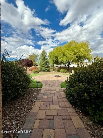 a view of a garden with plants and a pathway