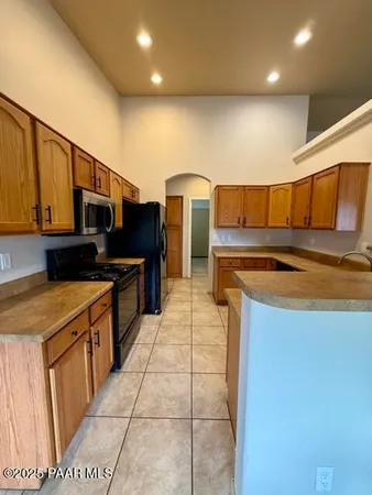 a kitchen with stainless steel appliances granite countertop a sink and cabinets