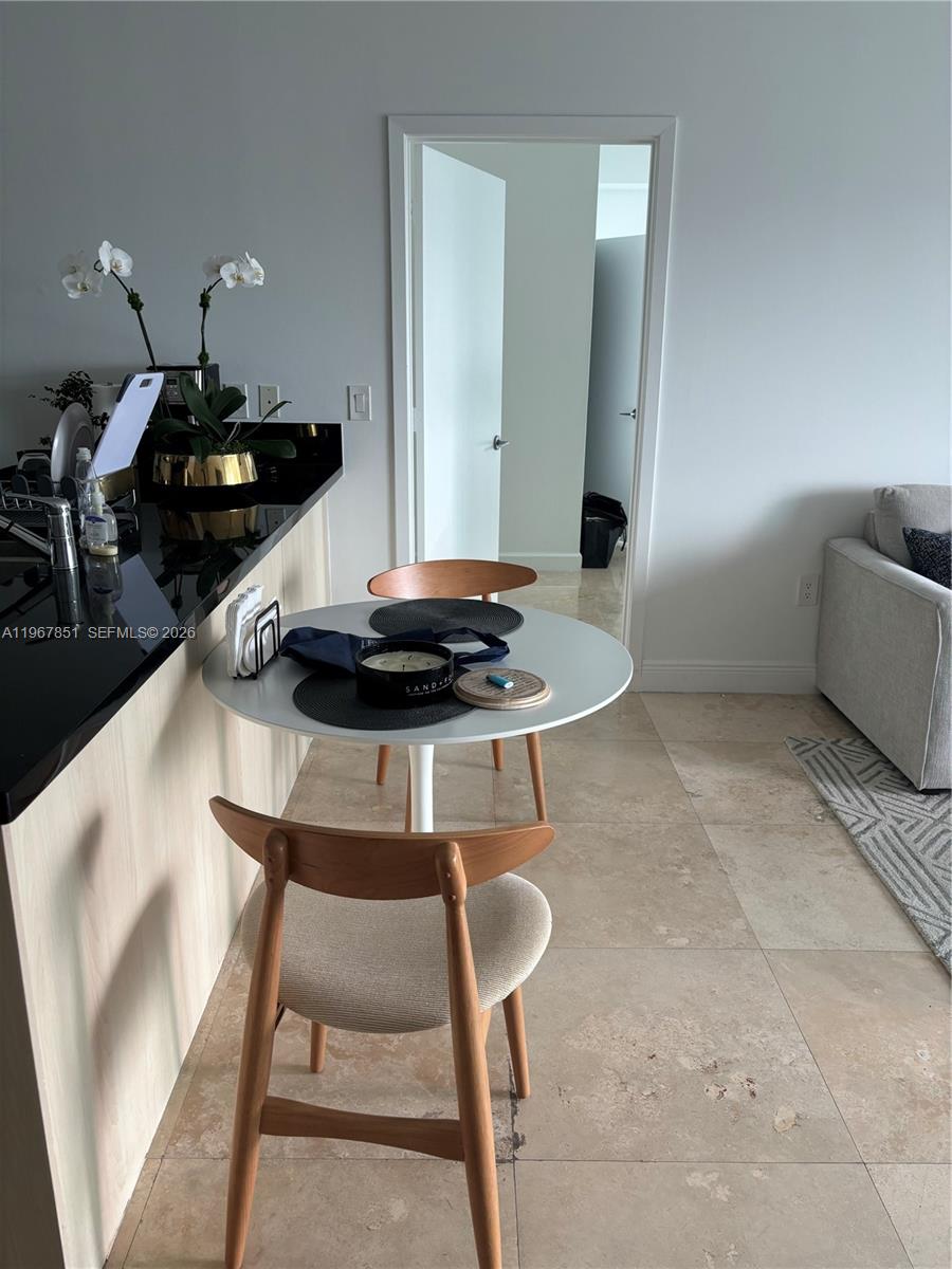 79 Southwest 12th Street, Unit 2703S Miami, FL 33130 - Photo 12 of 61 a living room with furniture and wooden floor