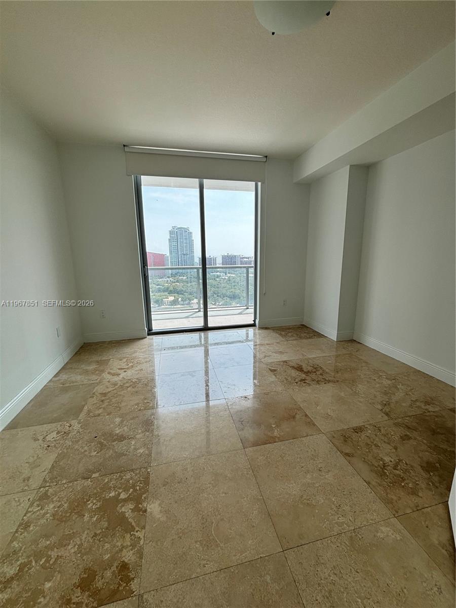 79 Southwest 12th Street, Unit 2703S Miami, FL 33130 - Photo 24 of 61 an empty room with sliding glass door