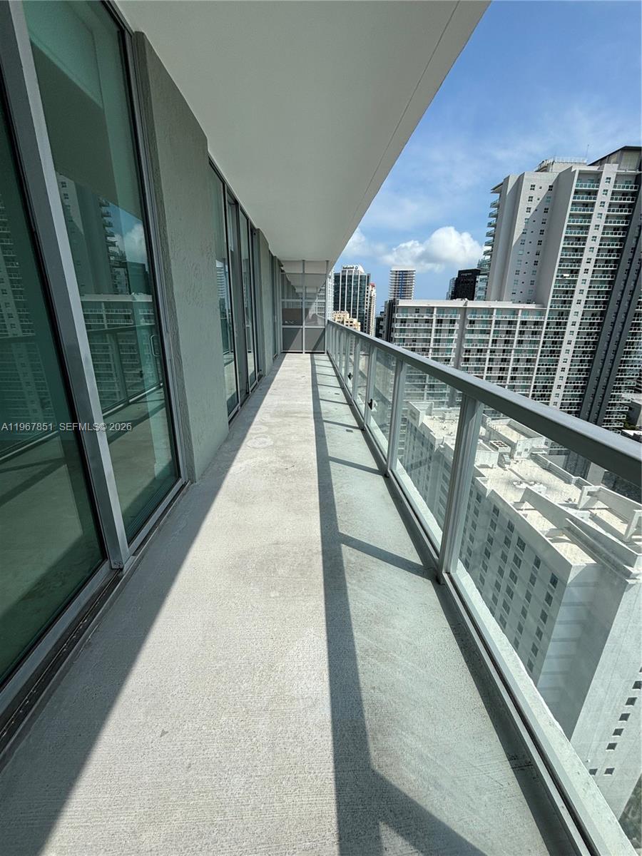 79 Southwest 12th Street, Unit 2703S Miami, FL 33130 - Photo 38 of 61 a view of balcony with wooden floor and stairs