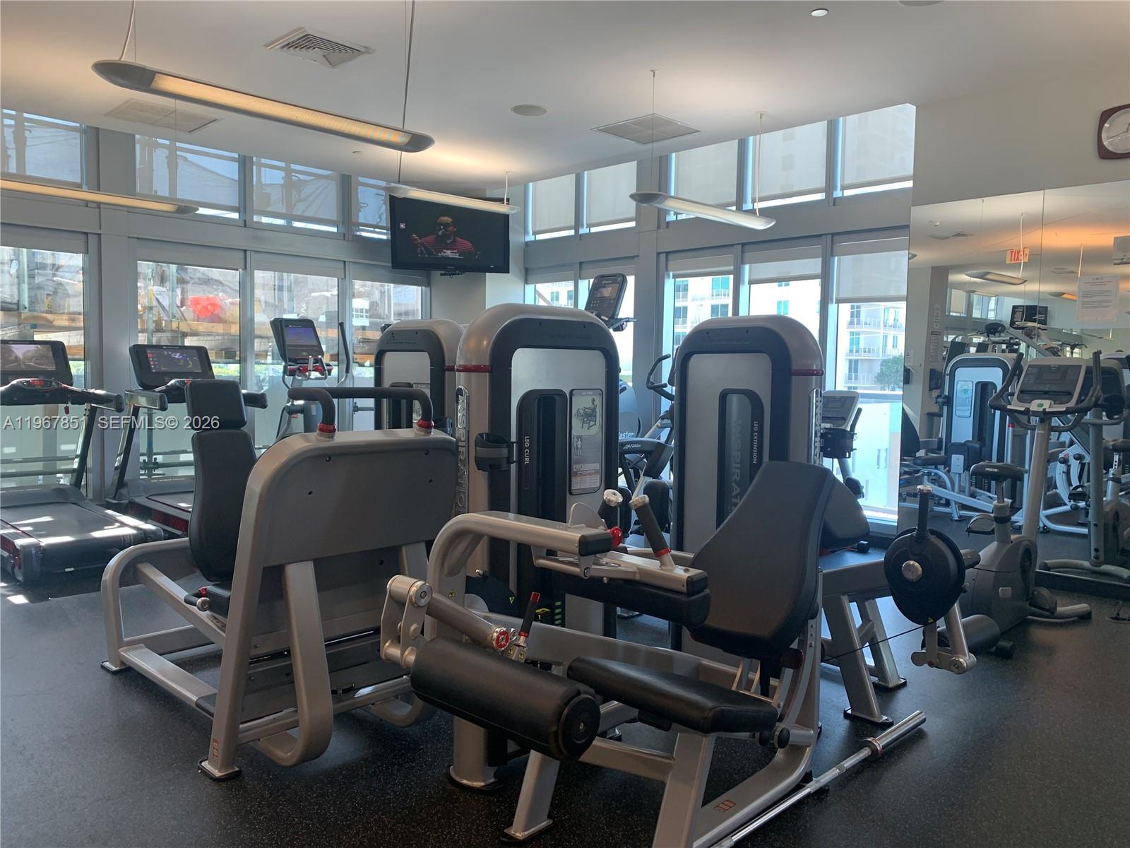 79 Southwest 12th Street, Unit 2703S Miami, FL 33130 - Photo 41 of 61 a dining room with furniture and chandelier