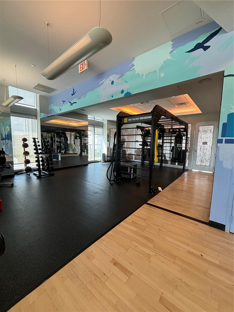 79 Southwest 12th Street, Unit 2703S Miami, FL 33130 - Photo 45 of 61 a kitchen with stainless steel appliances kitchen island a refrigerator a stove and a sink