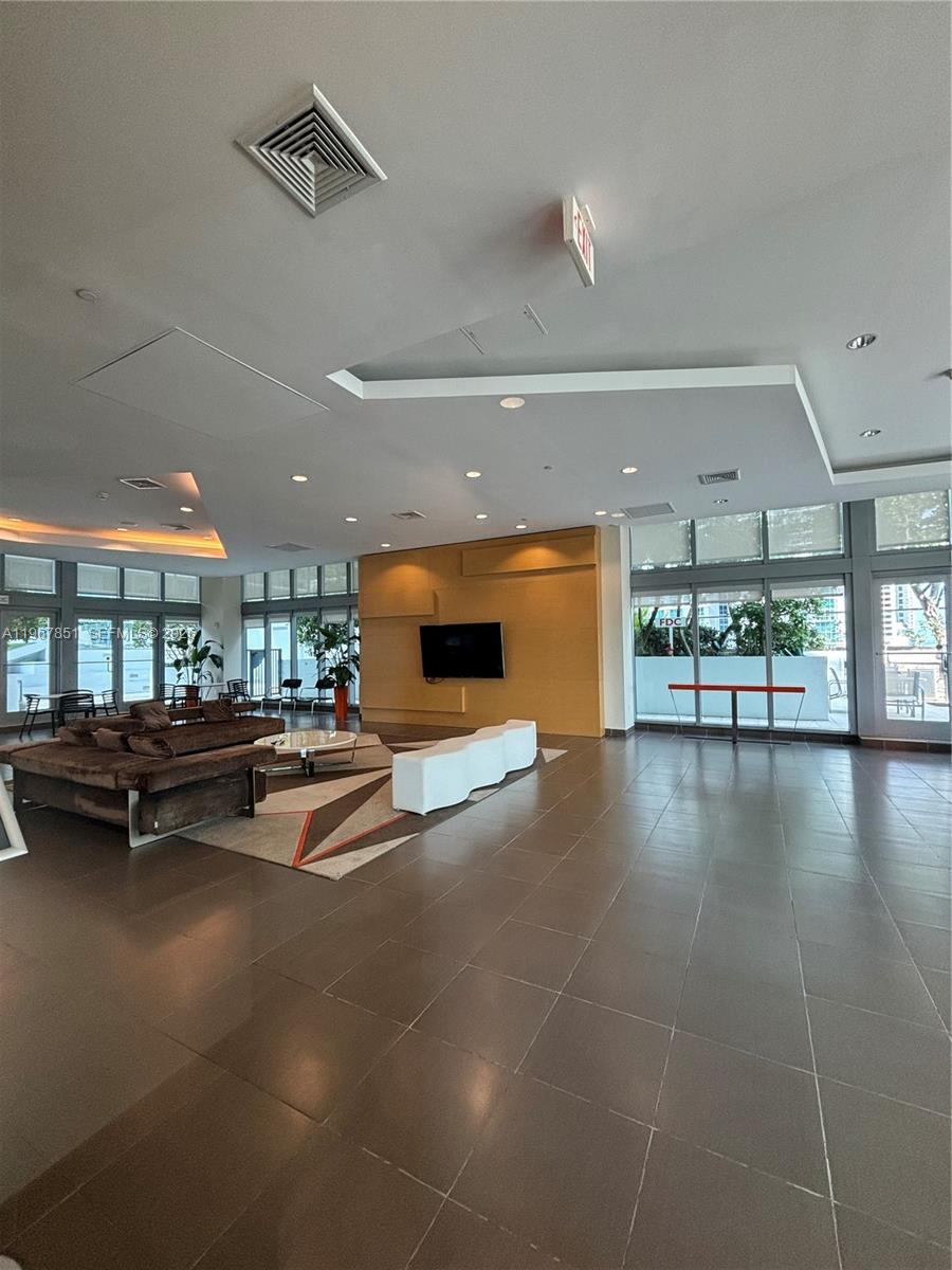 79 Southwest 12th Street, Unit 2703S Miami, FL 33130 - Photo 49 of 61 a living room with furniture and a pool