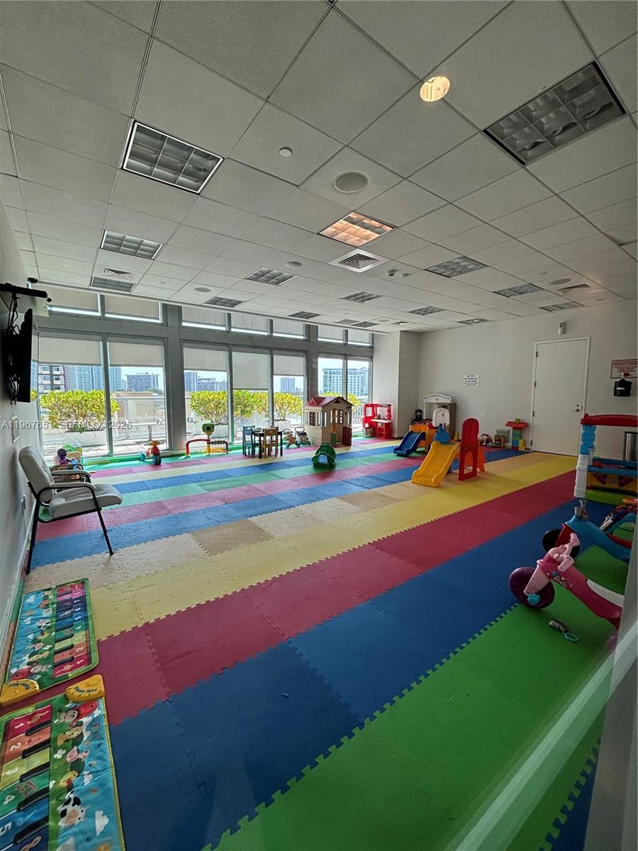 79 Southwest 12th Street, Unit 2703S Miami, FL 33130 - Photo 52 of 61 a room with pool table table soccer and windows