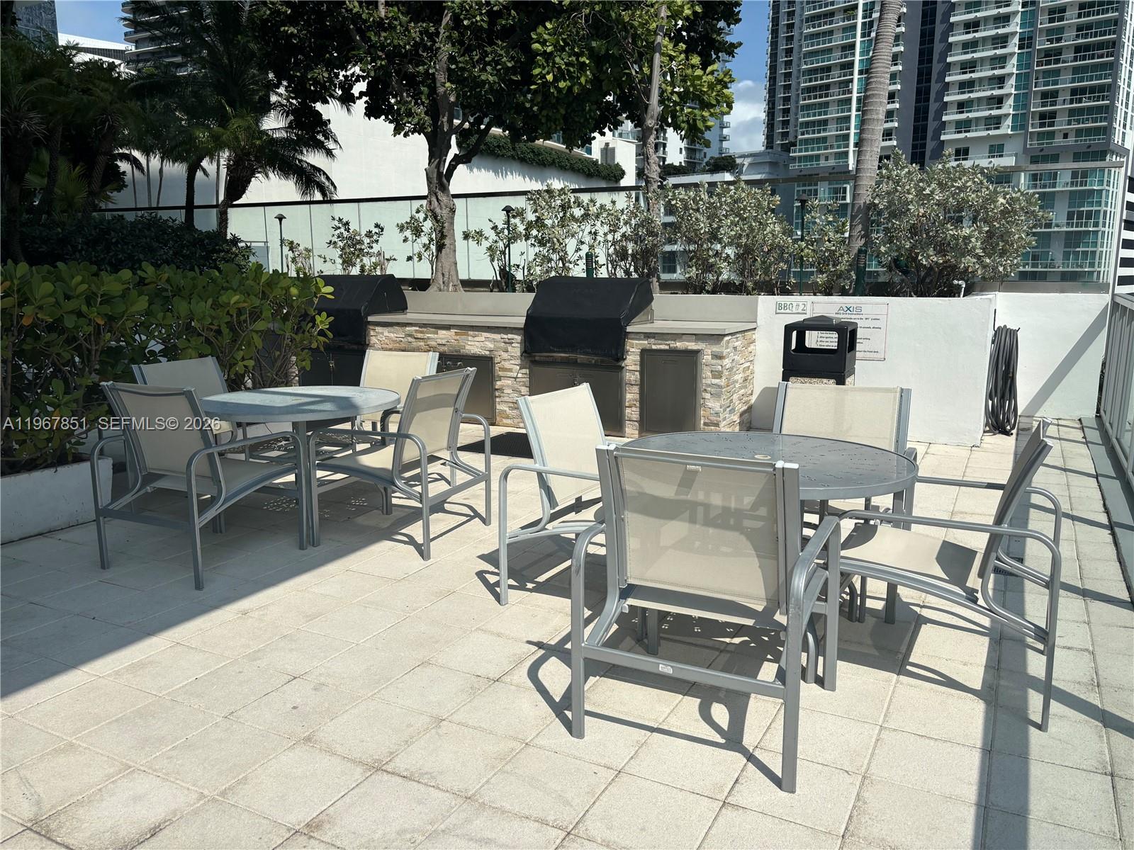 79 Southwest 12th Street, Unit 2703S Miami, FL 33130 - Photo 54 of 61 a view of a patio with table and chairs and potted plants