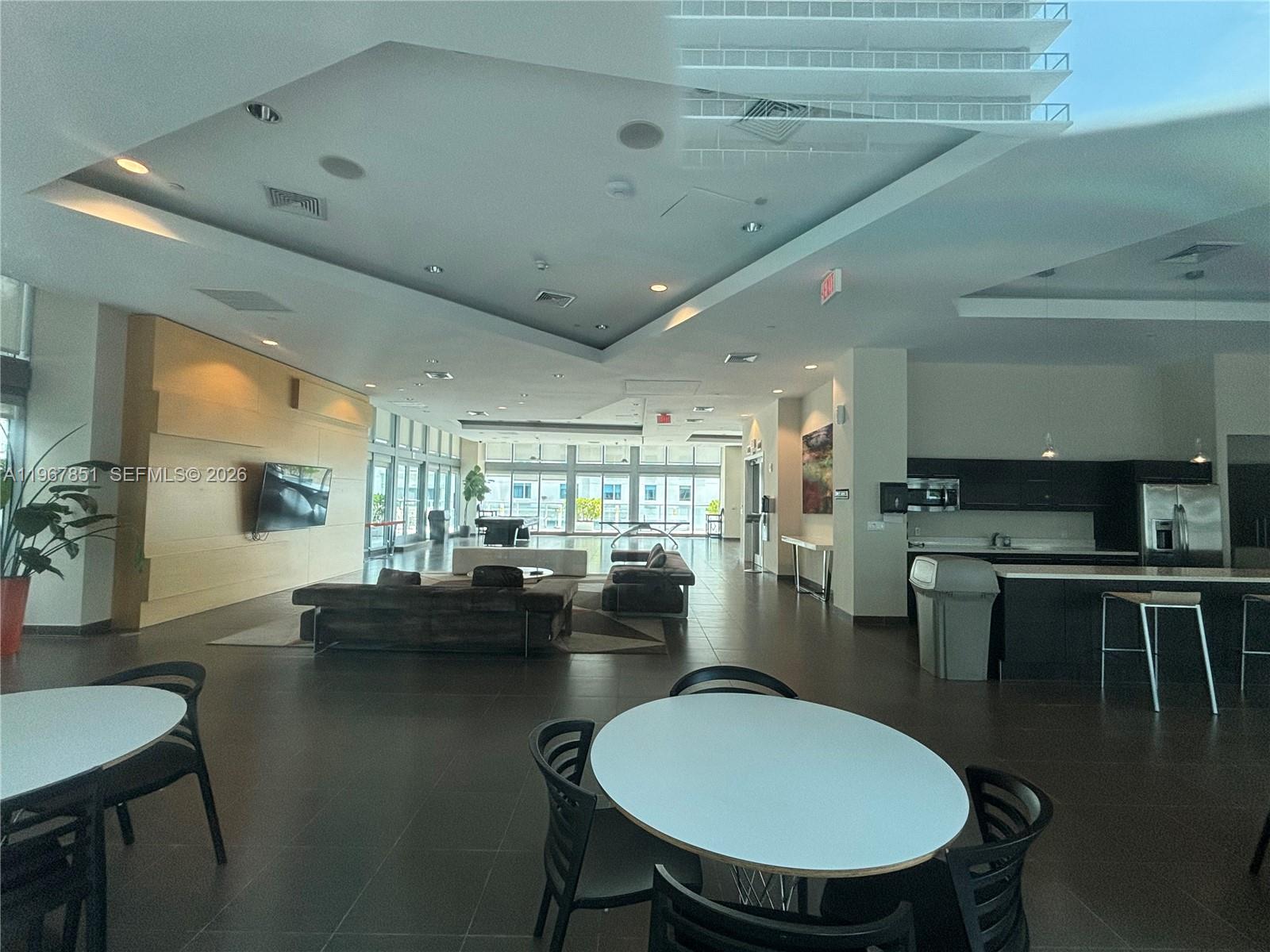 79 Southwest 12th Street, Unit 2703S Miami, FL 33130 - Photo 57 of 61 a kitchen with a dining table chairs stove and kitchen view