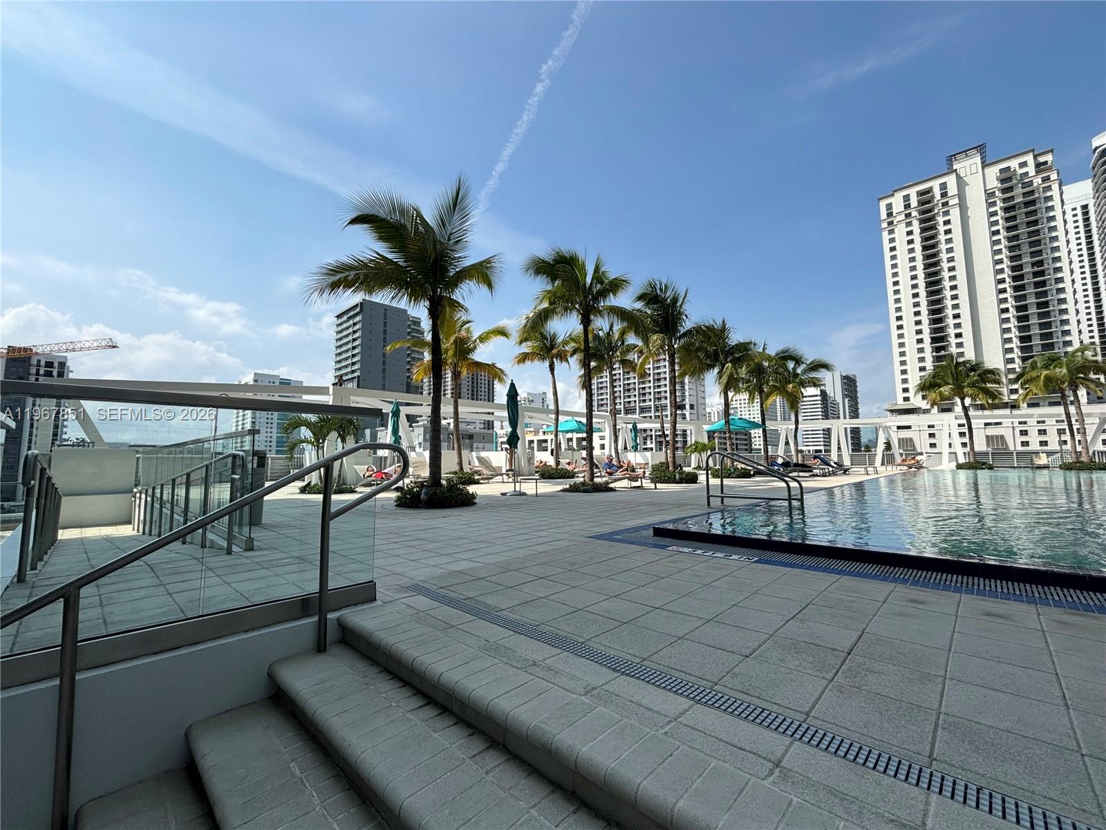 79 Southwest 12th Street, Unit 2703S Miami, FL 33130 - Photo 58 of 61 a view of swimming pool with outdoor seating and plants