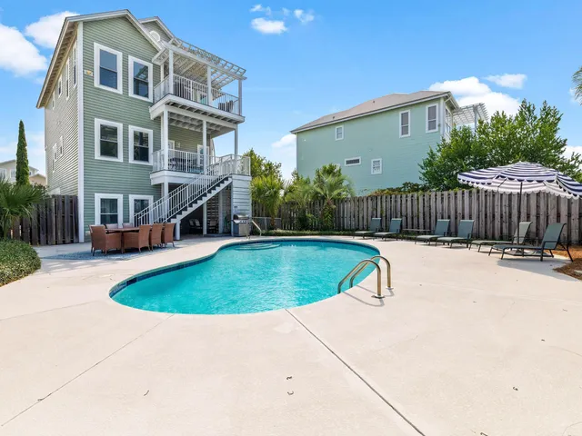 a view of a house with swimming pool and porch