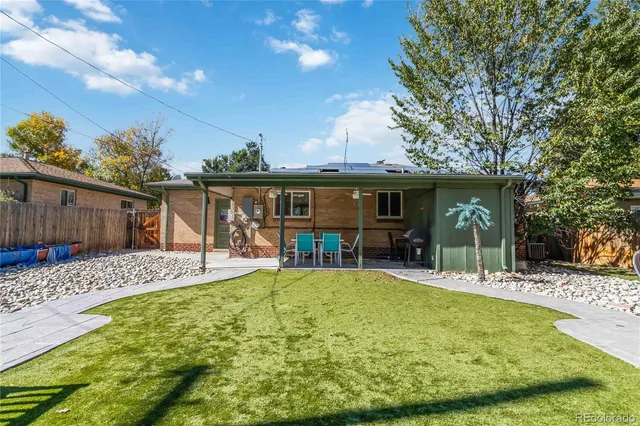 a view of a house with swimming pool and sitting area