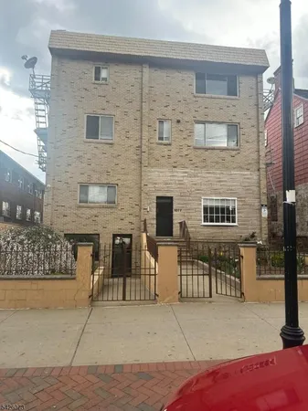 a brick building with a bench in front of it