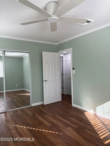a view of a big room with wooden floor and closet