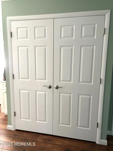 a view of an entryway with wooden floor