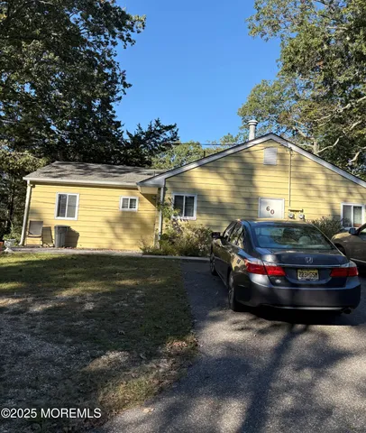 a view of swimming pool with lawn chairs and plants