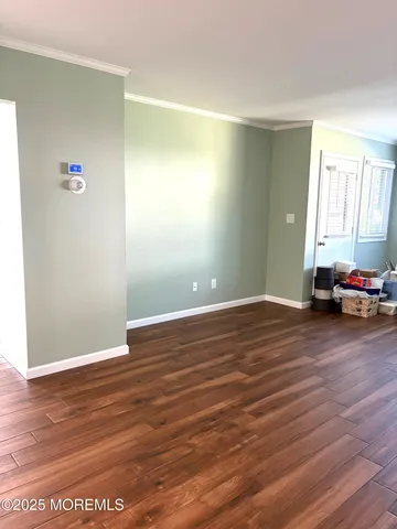 a view of a room with wooden floor