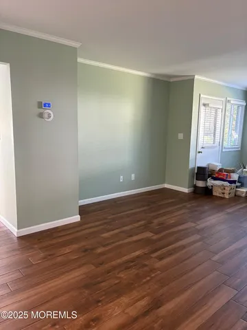 a view of a room with wooden floor