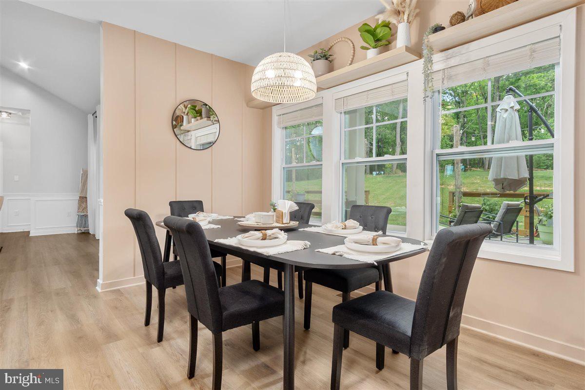 2390 Shirley Road Charles Town, WV 25414 - Photo 23 of 69 a view of a dining room with furniture a large window and wooden floor