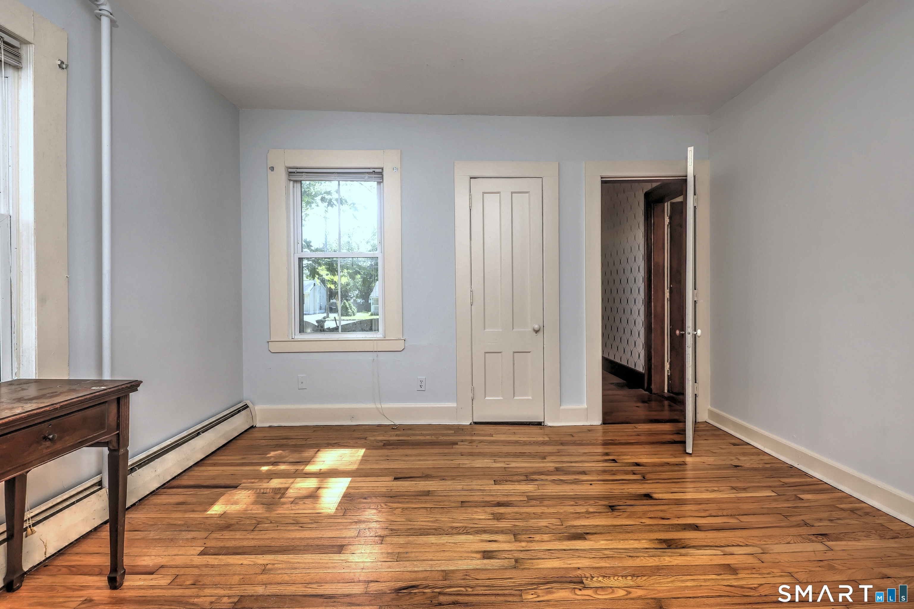 186 Jones Hill Road West Haven, CT 06516 - Photo 15 of 33 a view of empty room with window and wooden floor