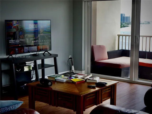 a living room with furniture and floor to ceiling windows