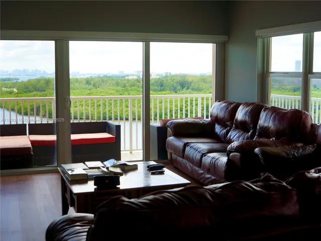 a view of a hallway and a livingroom with furniture