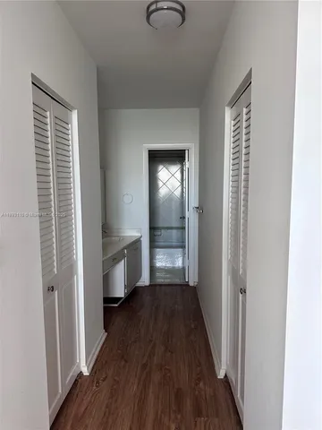 a living room with furniture and large windows