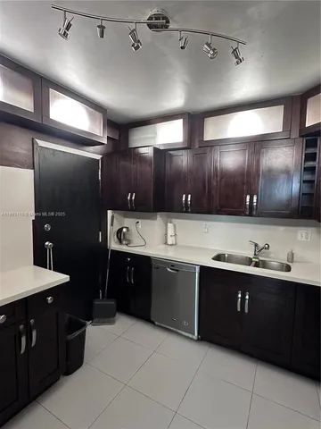 a large kitchen with a sink and dishwasher