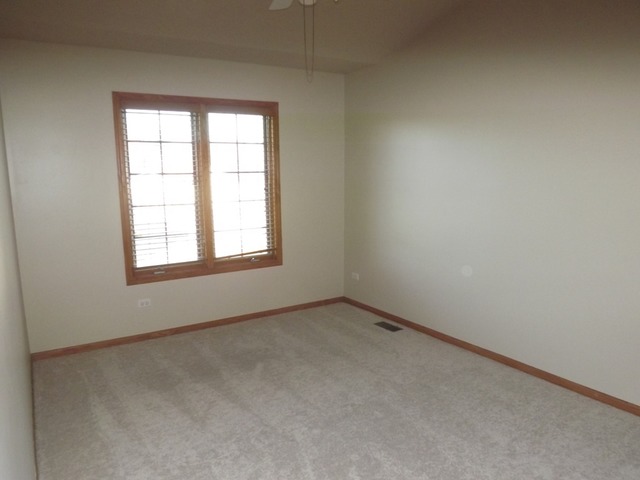 180 Grove Court, Unit 180 Lemont, IL 60439 - Photo 13 of 22 an empty room with a window