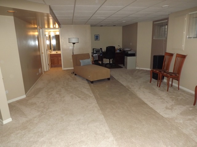 180 Grove Court, Unit 180 Lemont, IL 60439 - Photo 17 of 22 a living room with furniture and a chandelier