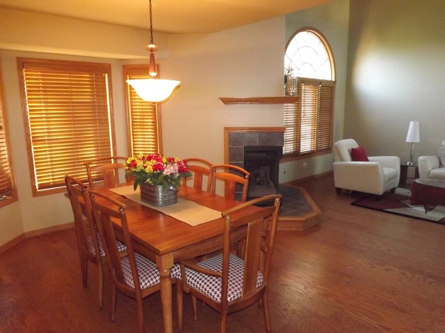 180 Grove Court, Unit 180 Lemont, IL 60439 - Photo 4 of 22 a dining room with furniture and a fireplace