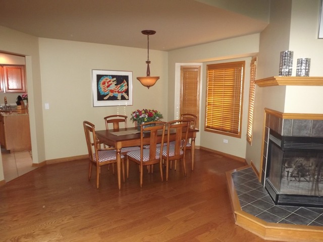 180 Grove Court, Unit 180 Lemont, IL 60439 - Photo 5 of 22 a view of a dining room with furniture window and wooden floor