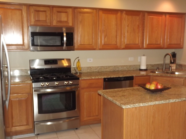 180 Grove Court, Unit 180 Lemont, IL 60439 - Photo 7 of 22 a kitchen with a stove and a microwave