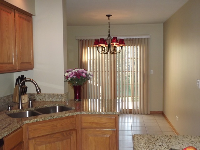 180 Grove Court, Unit 180 Lemont, IL 60439 - Photo 8 of 22 a front view of a house with a porch