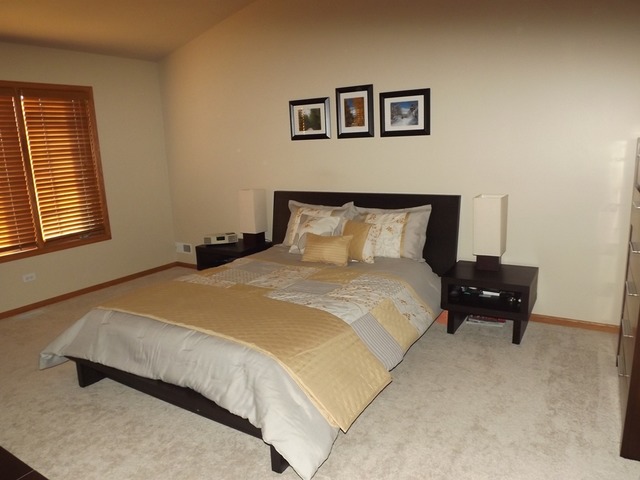 180 Grove Court, Unit 180 Lemont, IL 60439 - Photo 9 of 22 a bedroom with a bed and wooden floor