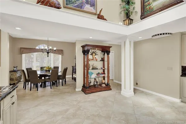 a dining room with furniture a chandelier and window