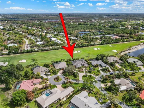 a view of a patio with couches table and chairs and potted plants